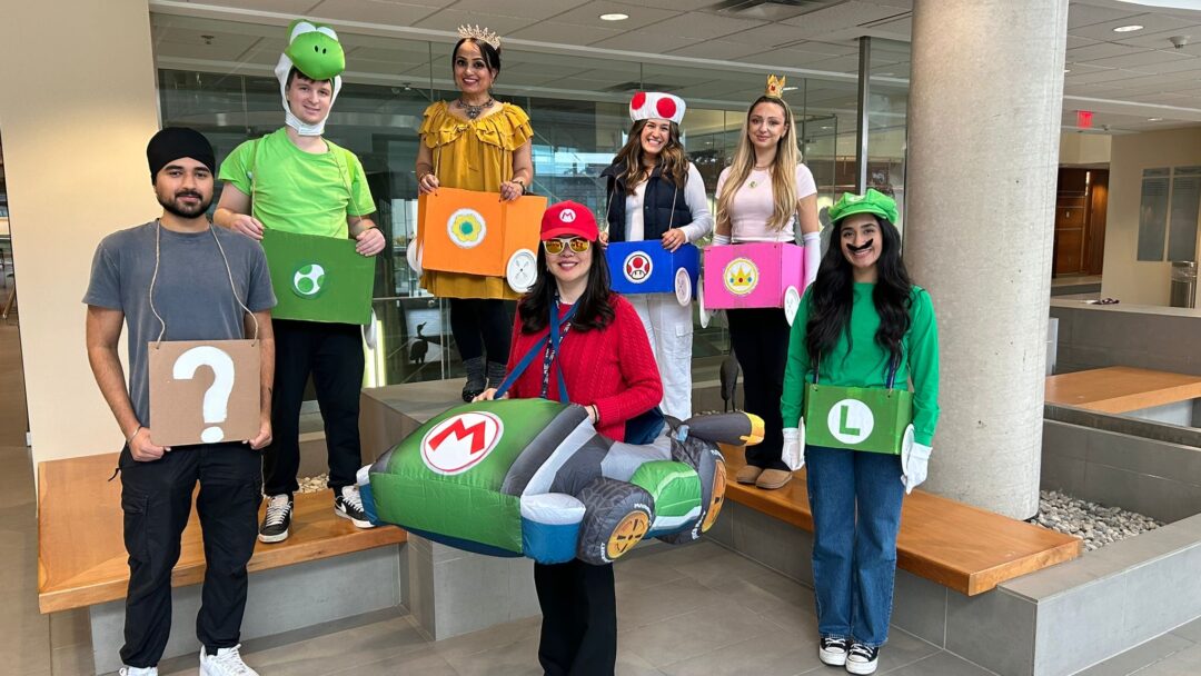 A group of people pose in Mario Kart inspired halloween costumes