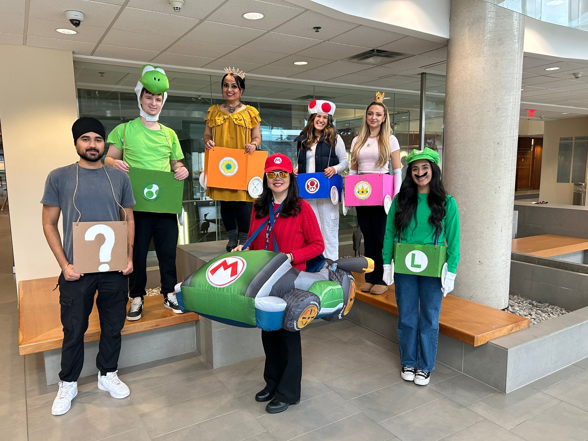 A group of people pose in Mario Kart inspired halloween costumes