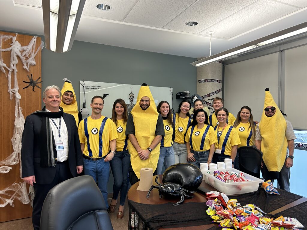 People in yellow minion and banana halloween costumes