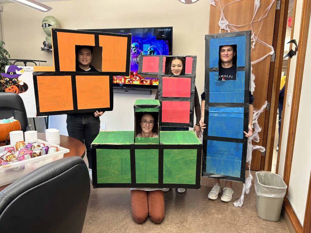 A group of people pose in Tetris block halloween costumes