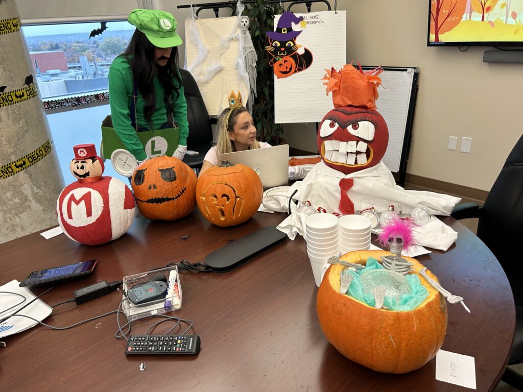 A table covered with pumpkins decorated for Halloween